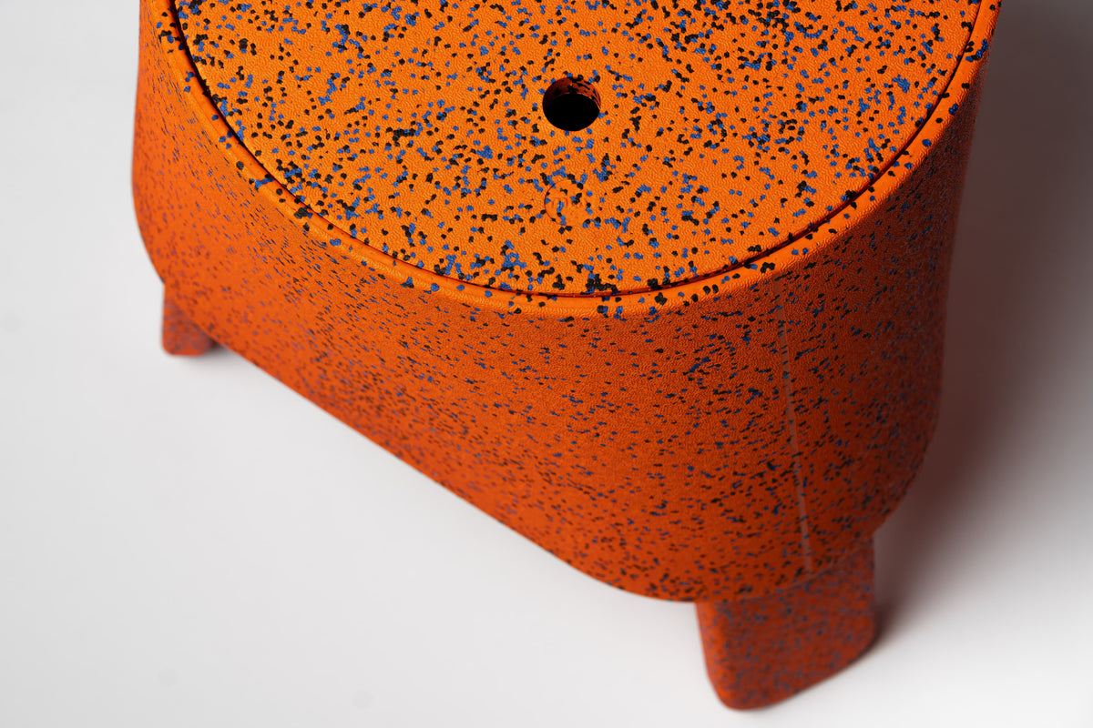 Close-up of the textured expanded polypropylene surface of AYTO Orange Mix with the hole in the lid