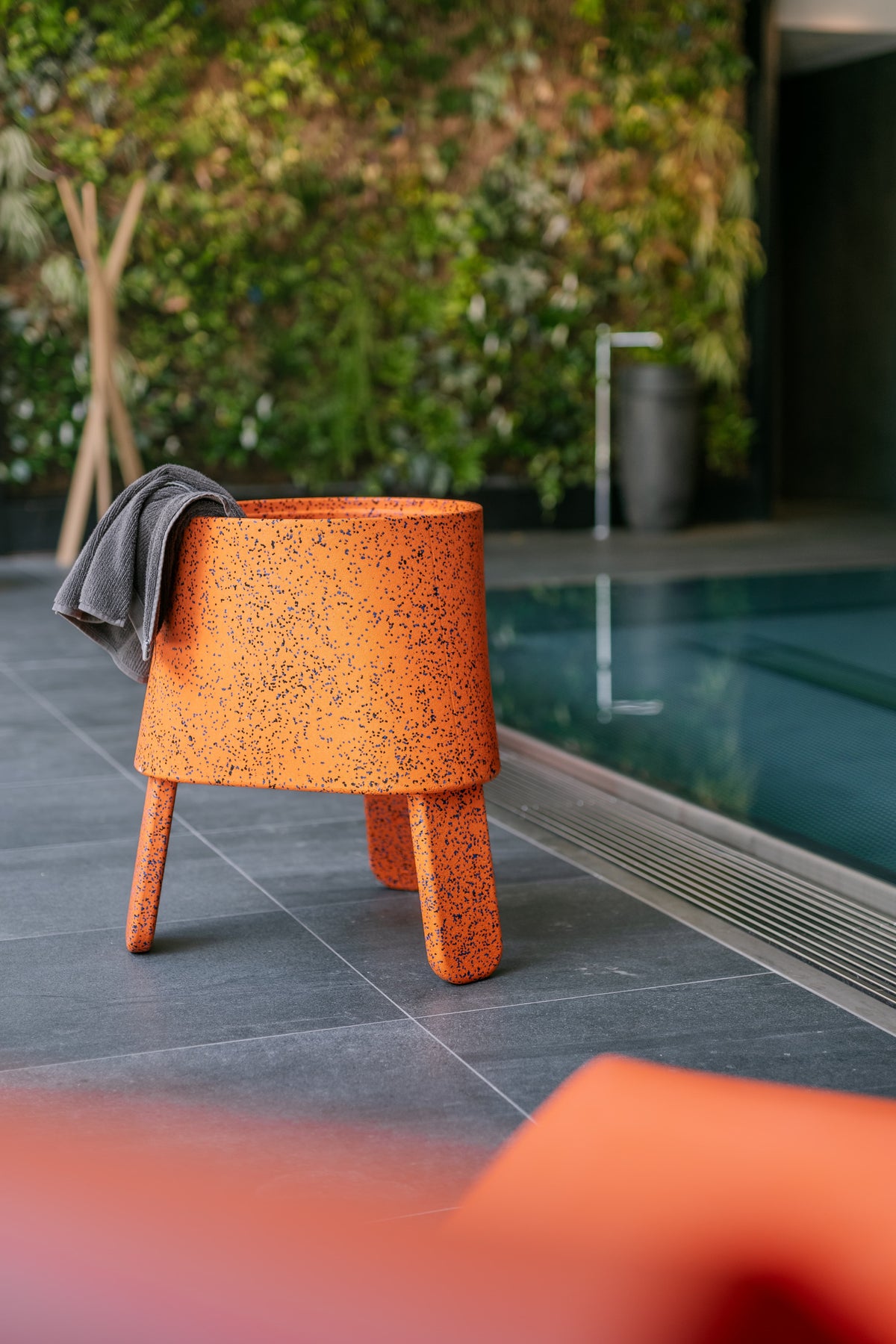 AYTO Orange Mix used as a side table with a towel next to a pool on a terrace